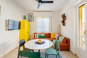 a living room with a table and a couch at La casetta POP in Bordighera