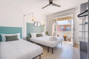 a bedroom with two beds and a window at La casetta POP in Bordighera