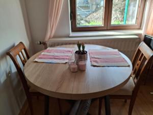 a wooden table with two napkins on top of it at La Vie en Rose in Ensival