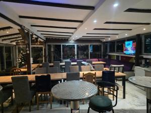 a restaurant with tables and chairs and a tv at vila darkoni in Bijeljina