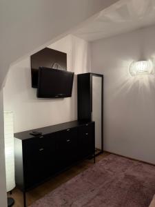 a living room with a flat screen tv on the wall at Pokoje Felix in Słupsk