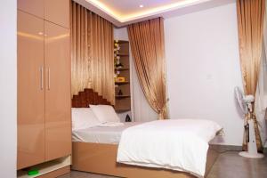 a bedroom with a white bed and a closet at Nestoria in Sagisa