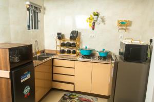 a kitchen with a stove and a refrigerator and a microwave at Nestoria in Sagisa
