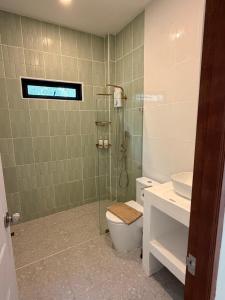 a bathroom with a shower and a toilet and a sink at Srithanu Escape 1 in Srithanu +20 photos
