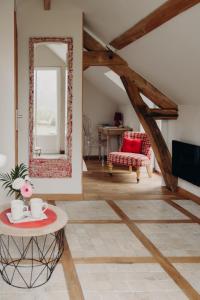 a living room with a mirror and a table at La Marmittiere in Civray-de-Touraine