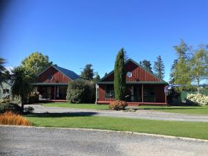 a house with a red roof at Cedar Chalets in Methven