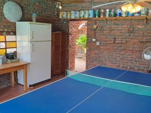 a blue ping pong table in a kitchen with a refrigerator at Carey 43 in Bothaville