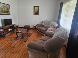 a living room with two couches and a tv at Carey 43 in Bothaville
