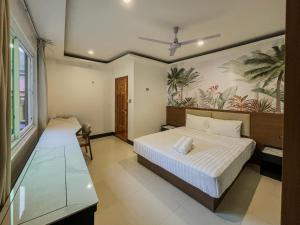 a bedroom with two beds and a painting on the wall at The Town - By Namal in El Nido