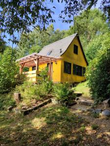 a yellow house with a metal roof at Berghütte am Grenzwinkel in Sebnitz +10 photos