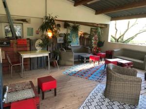 a living room with couches and chairs and a table at ZEcamping 2 piscine animaux acceptés in Galeria