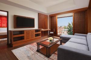 a living room with a couch and a tv at The Soaltee Kathmandu, Autograph Collection in Kathmandu
