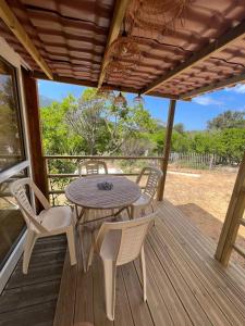 a wooden deck with a table and chairs on it at ZEcamping 2 piscine animaux acceptés in Galeria