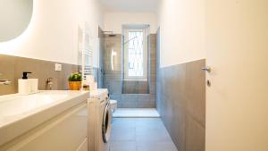 a bathroom with a sink and a toilet and a shower at Ramazzini District – Elegant Flat x8 in Milan