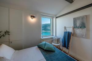 a bedroom with a bed and a window at Casa Emily in Portovenere