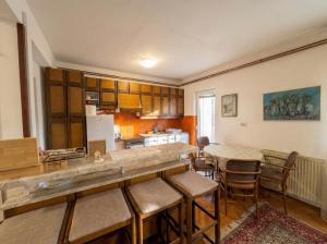 a kitchen with a counter and a table and chairs at Golden Bay Apartment in Kotor