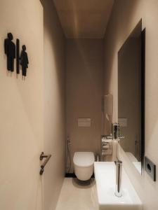 a bathroom with a white toilet and a sink at GettSleep Madrid Airport T4S - Boarding Pass Required in Madrid