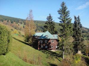 a large house on a hill in a field at Chata Jablunka, Dog friendly, 50m ski slope, 50m restaurant in Pec pod Sněžkou
