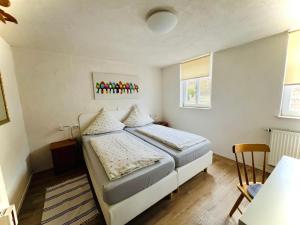 a small bedroom with a bed and a table at Gasthaus Rose in Niedernhall