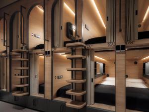 a room with four bunk beds and a staircase at GettSleep Madrid Airport T4S - Boarding Pass Required in Madrid +23 photos