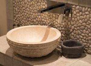 a bathroom with a large stone sink on a counter at Rantum Lodge in Rantum +8 photos