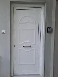 a white door with a silver handle on it at Aspasia's apartment in Mytilene