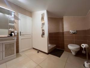 a bathroom with a toilet and a sink at Ain’Time in Biziat