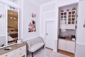 a dressing room with a chair and a mirror at Casa Baritiu - budget in Braşov +52 photos