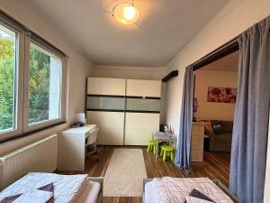 a bedroom with a bed and a desk and a room at Erika's House. in Érd