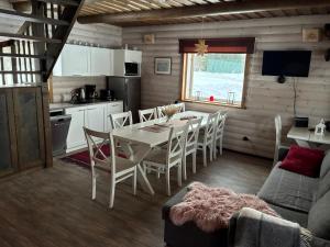 a kitchen and dining room with a table and chairs at Lammasmäe Puhkekeskus in Linnuse +13 photos