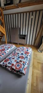 a bed with a quilt on it in a room at Appartment Paula in Heinsdorfergrund