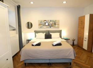 a bedroom with a large bed with two pillows on it at DJ Pula Studio - City Center in Pula