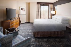 a hotel room with a bed and a flat screen tv at Crowne Plaza Annapolis, an IHG Hotel in Annapolis