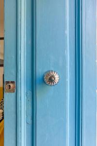 a blue door with a metal button on it at Floriana Cozy Haven in Il-Furjana