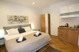 a bedroom with a large bed with two towels on it at DJ Pula Studio - City Center in Pula