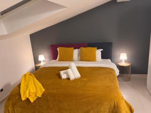 a bedroom with a large bed with towels on it at Bella Tao Apart in Taormina