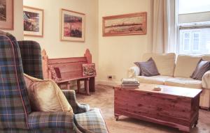 a living room with a couch and a piano at Fisherman's Cottage in Cockenzie