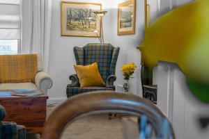 a living room with two chairs and a lamp at Fisherman's Cottage in Cockenzie +47 photos