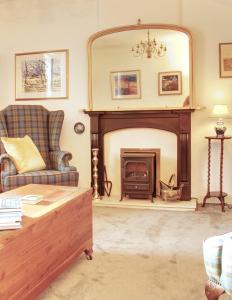 a living room with a fireplace and a couch at Fisherman's Cottage in Cockenzie