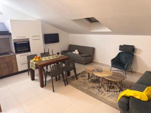 a kitchen and living room with a table and chairs at Bella Tao Apart in Taormina