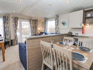 a kitchen and living room with a table and chairs at Plot 42 in Carlisle