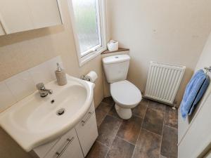 a bathroom with a sink and a toilet and a window at Plot 42 in Carlisle +12 photos