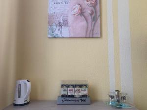 a counter with a coffee maker and a picture on the wall at Hotel Schwarzes Ross Siebenlehn in Siebenlehn