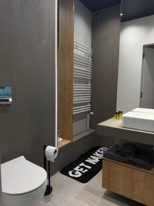 a bathroom with a white toilet and a sink at ALEKSANDRA 5 - Leaf in Kielce +24 photos
