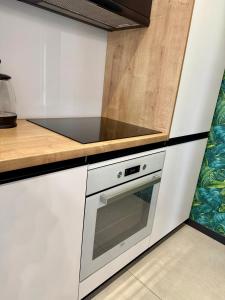 a kitchen with white cabinets and a stove top oven at ALEKSANDRA 5 - Leaf in Kielce