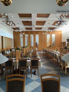 a row of tables and chairs in a dining room at 1A Landhotel Schicklberg in Kremsmünster