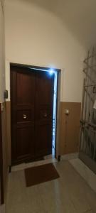 a room with a large wooden door in a room at Silvia Butterfly Flat in Genoa