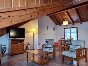 a living room with two chairs and a television at Ramonet in Son