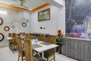 a dining room with a table and chairs and a fountain at Townhouse Hotel Vaishnavi Inn in Lucknow