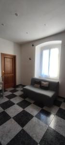 a living room with a couch and a window at Silvia Butterfly Flat in Genoa